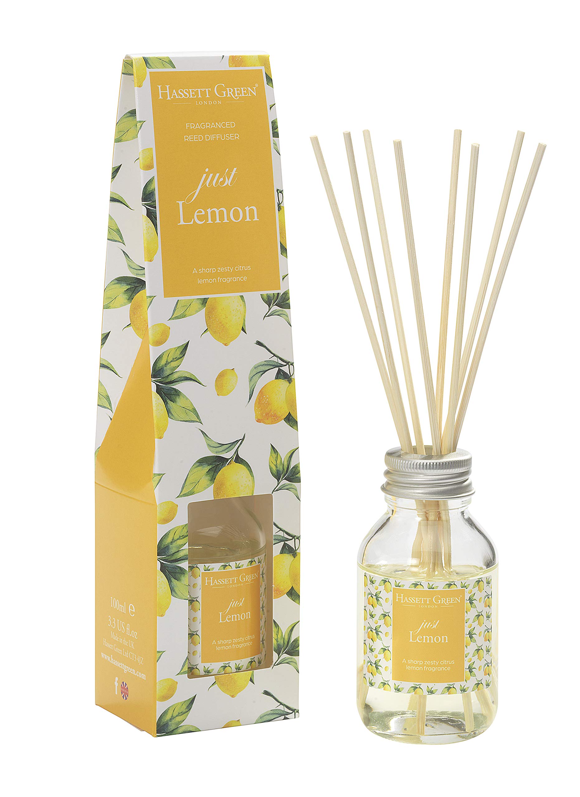 A Just Lemon reed diffuser with a clear glass bottle and wooden sticks, packaged in a yellow and white box adorned with lemon illustrations.
